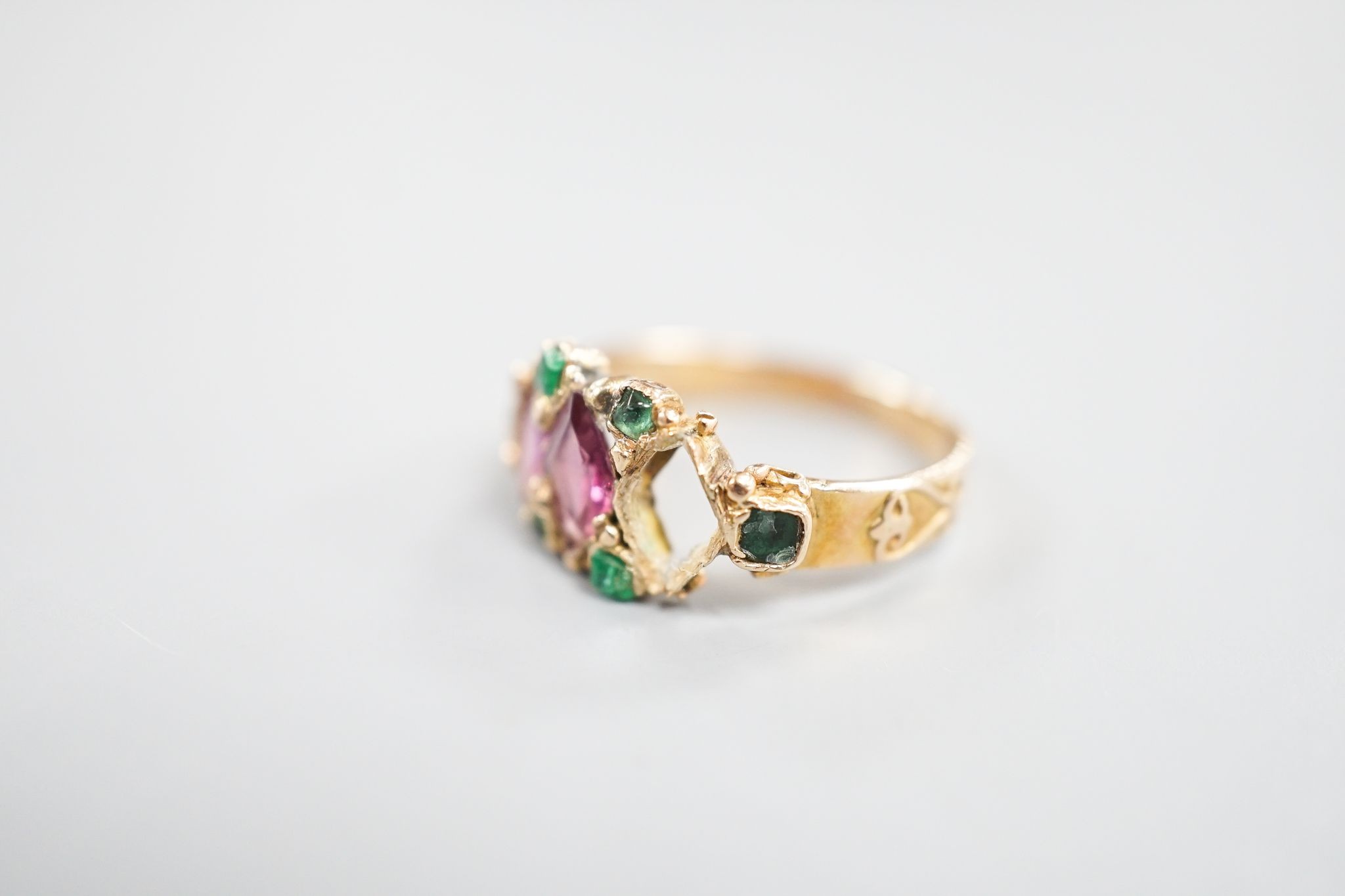 A late Victorian 15ct gold, garnet and emerald set dress ring(stone missing & stone replacement?), size L, gross 2.2grams.